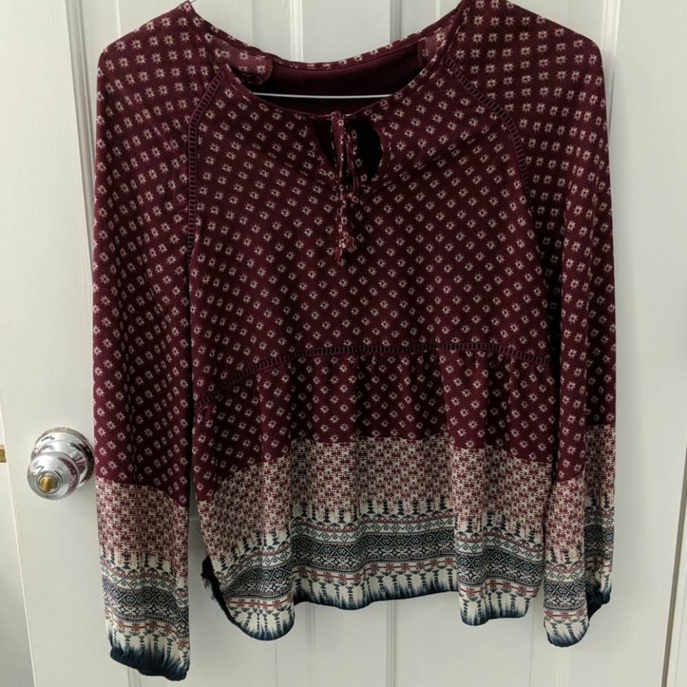 Deep cranberry colored blouse.